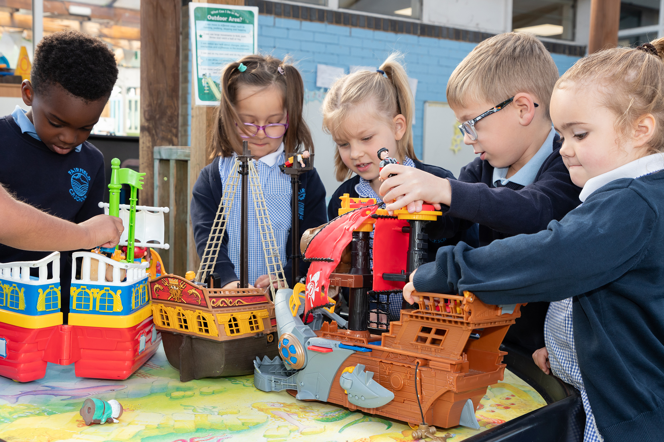 children playing outdoors at fairfield eyfs